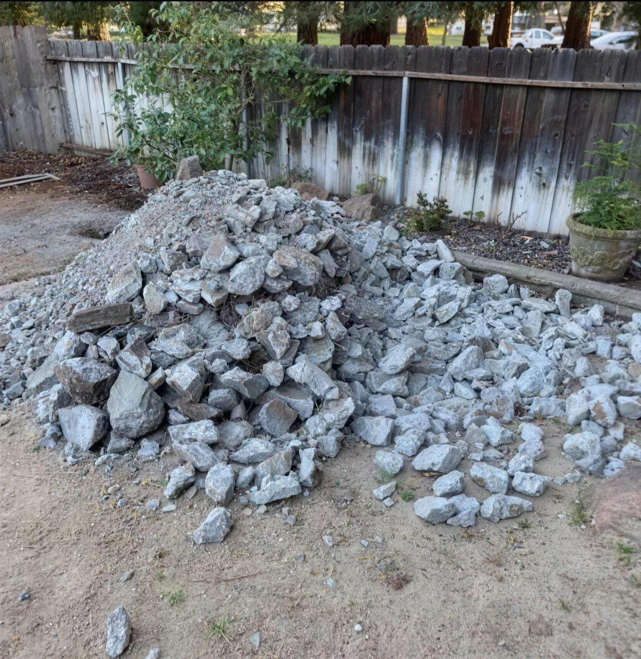 Before: pile of broken concrete filling a backyard